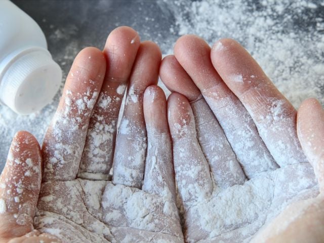 Baby powder on a person's hands